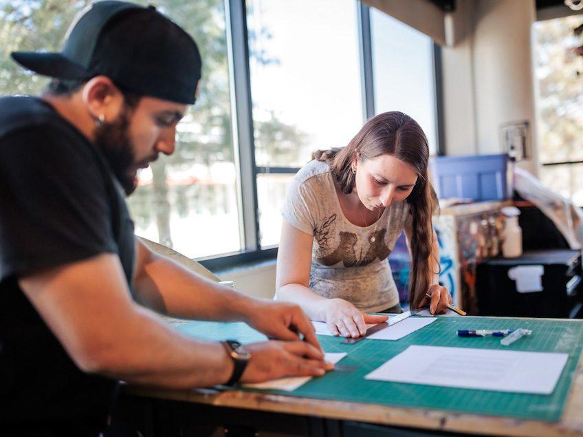 MSU Denver student Jamie McCurdy cuts paper in Painting and New Contexts class on May 3, 2023. Photo by Alyson McClaran