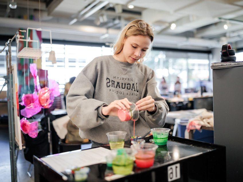 MSU Denver student, Avery Jacobson pours paint in Painting and New Contexts class on May 3, 2023. Photo by Alyson McClaran