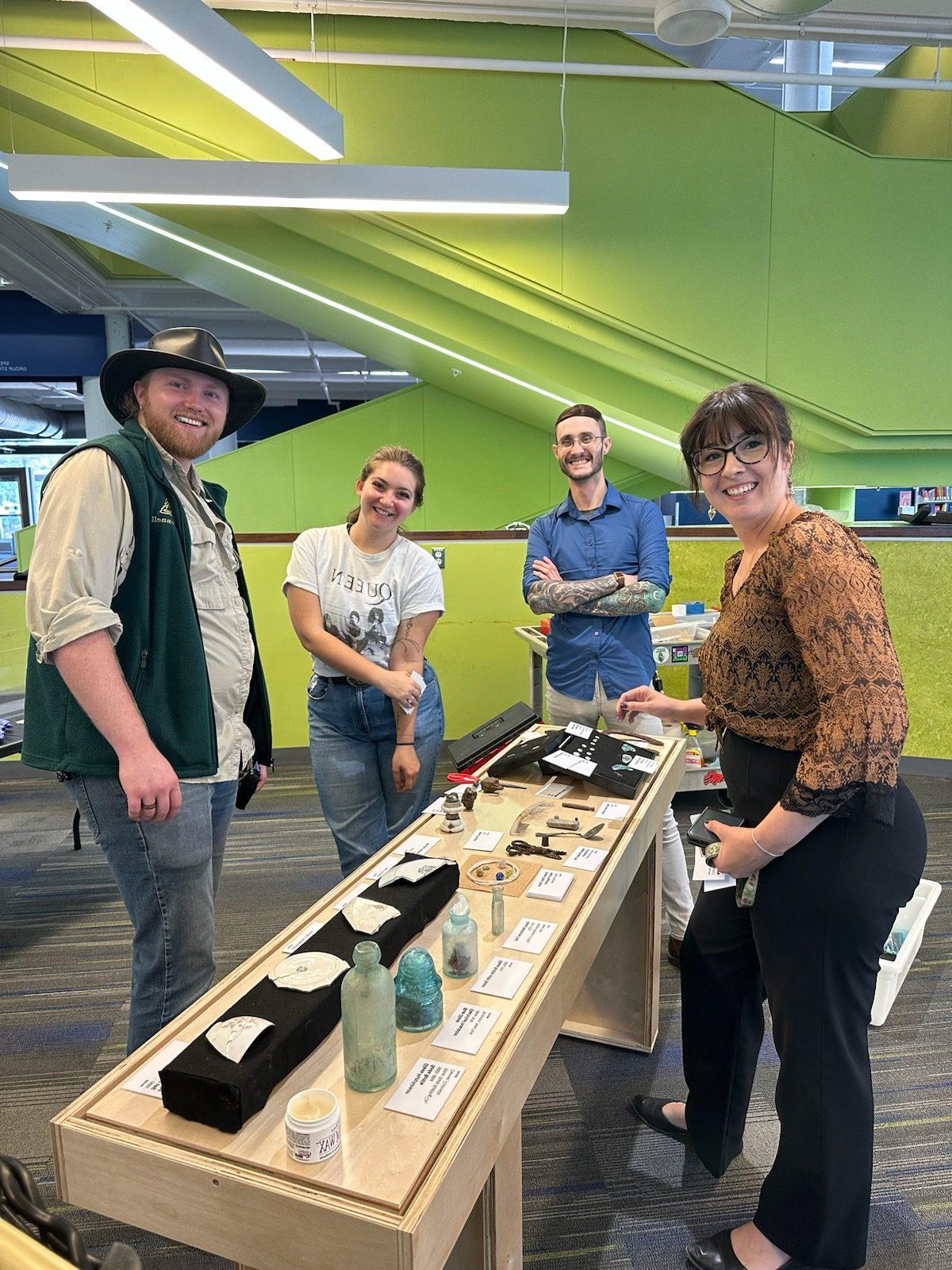 Anthropology faculty and students setting up Auraria archaeology display in the Auraria Library.